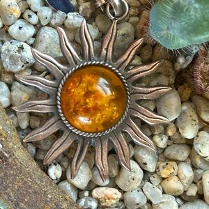 Unusual golden amber pendant in sun setting